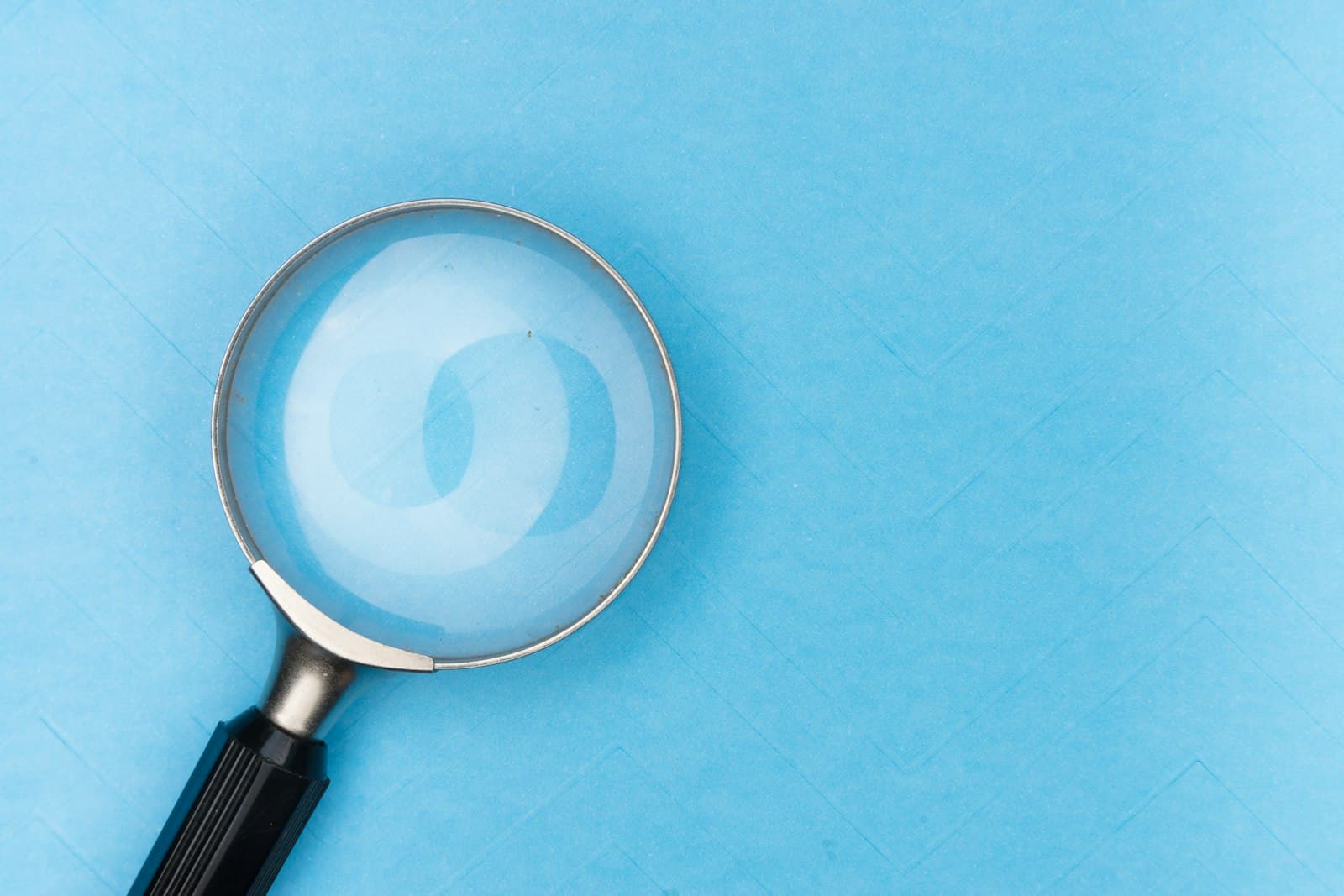 A magnifying glass on a white table