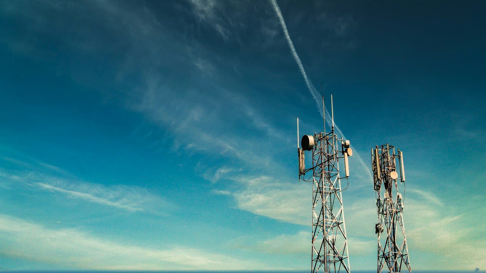 A telecommunications mast against a blue sky