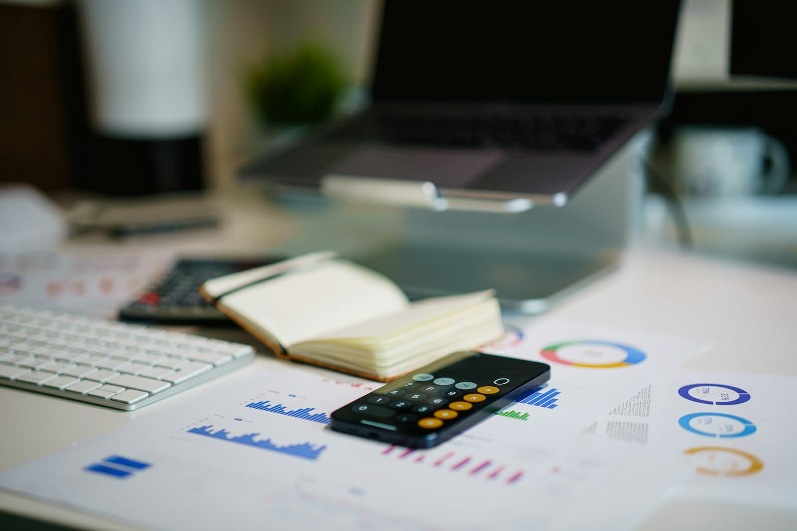A desk with a smartphone and financial charts