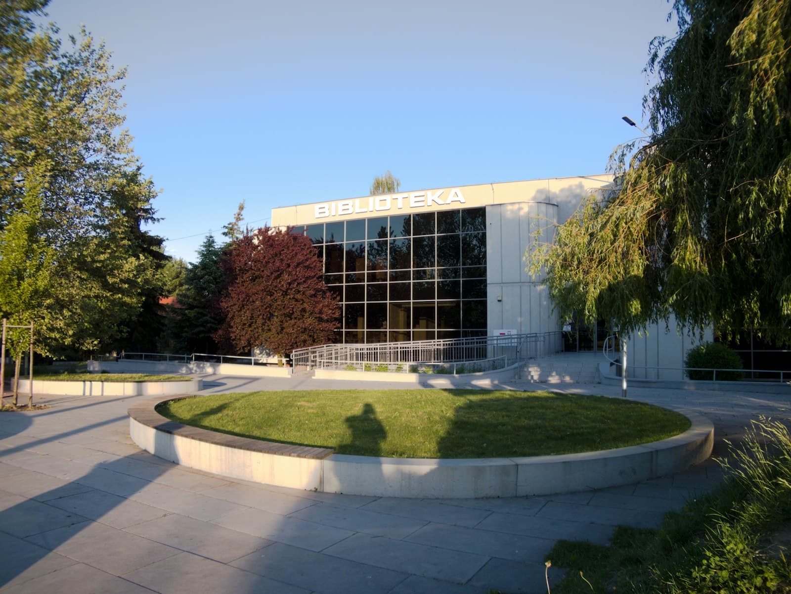 A modern community building with a circular lawn